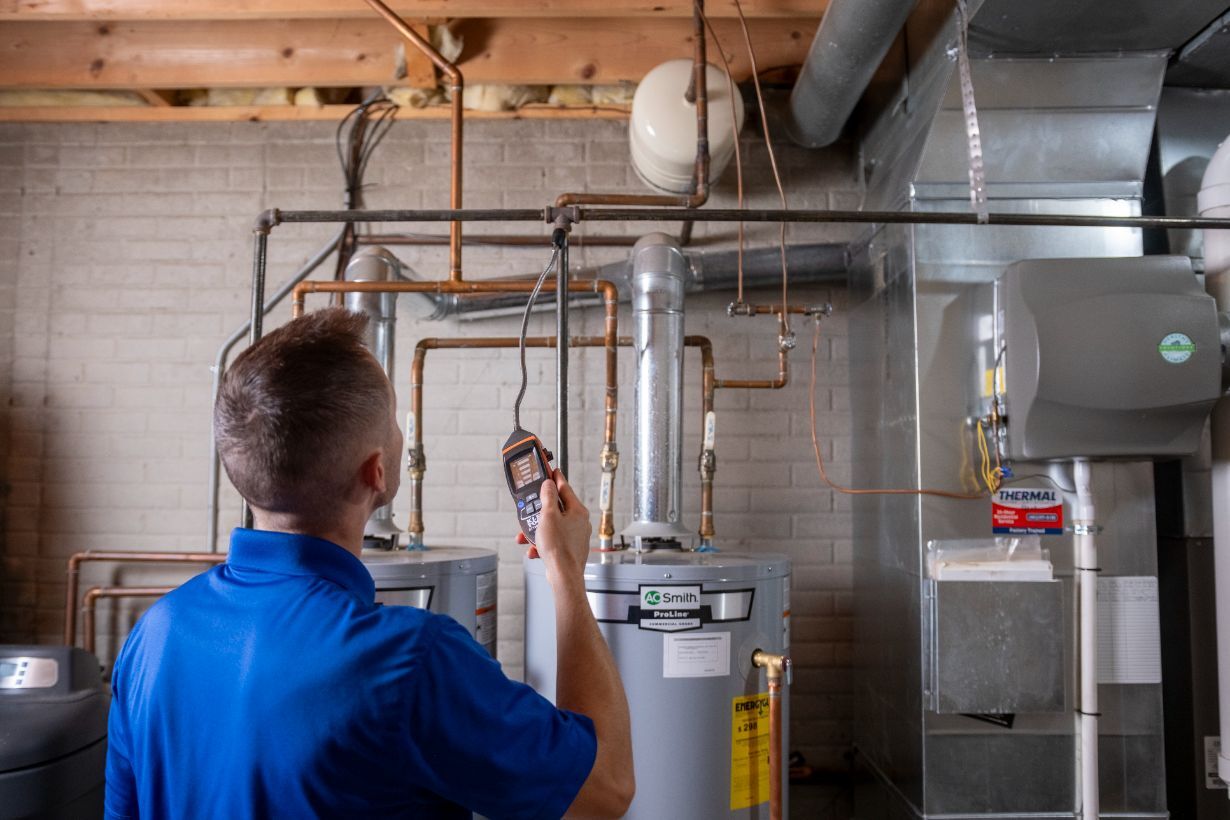 Plumber checking on a water heater after installing it